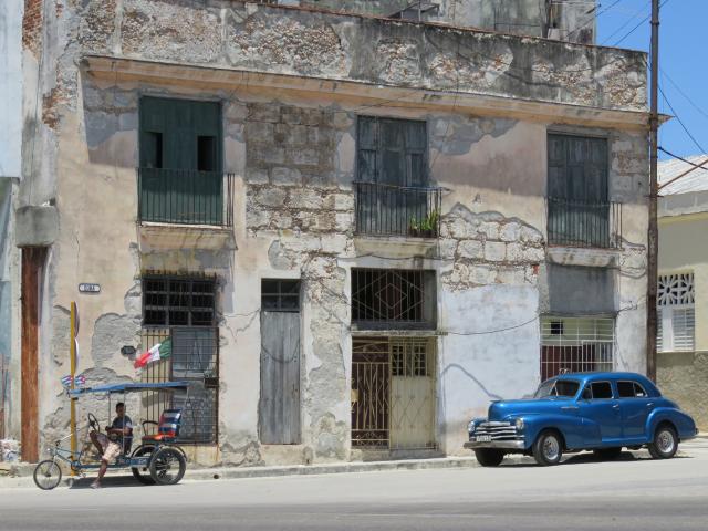 Building in Cuba with car in front.